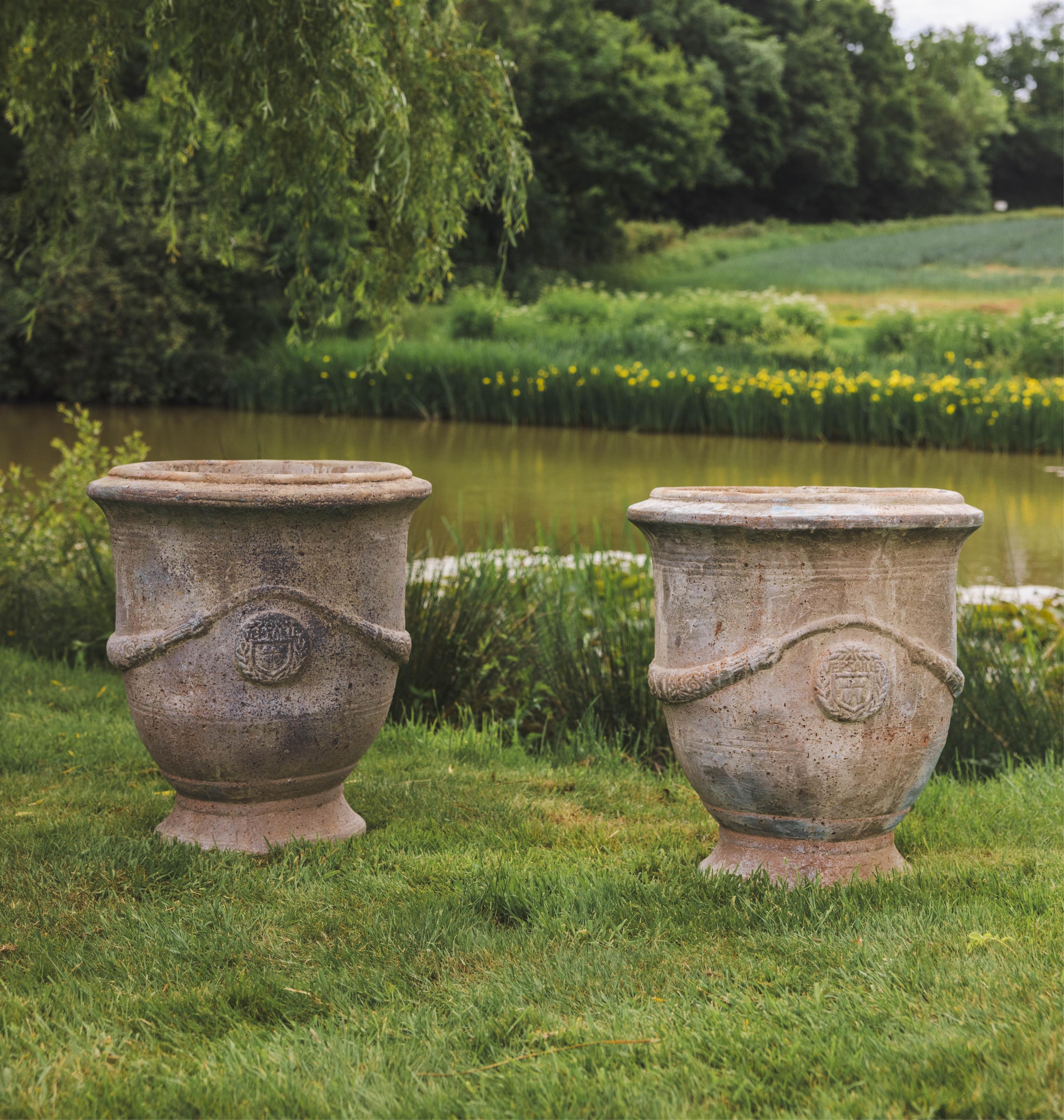 A pair of large circular earthenware garden planters, diameter 61cm, height 68cm